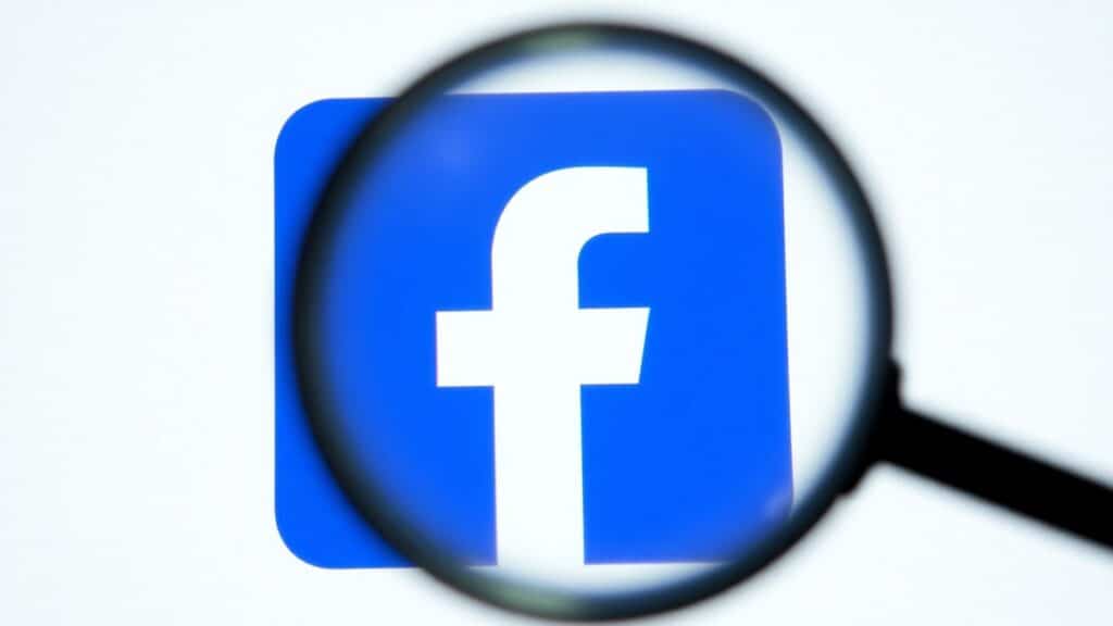 Facebook logo with magnifying glass highlighting quality content.
