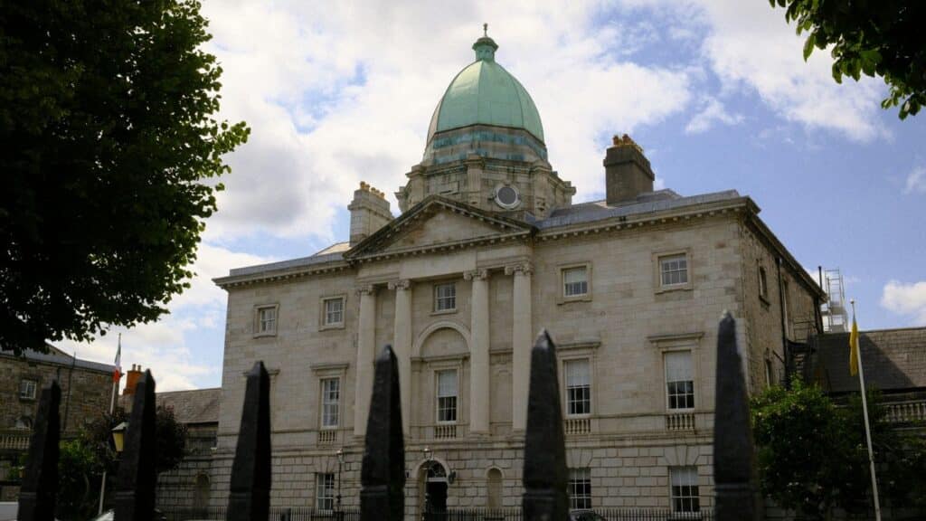 A grand building stands beneath a cloudy sky.