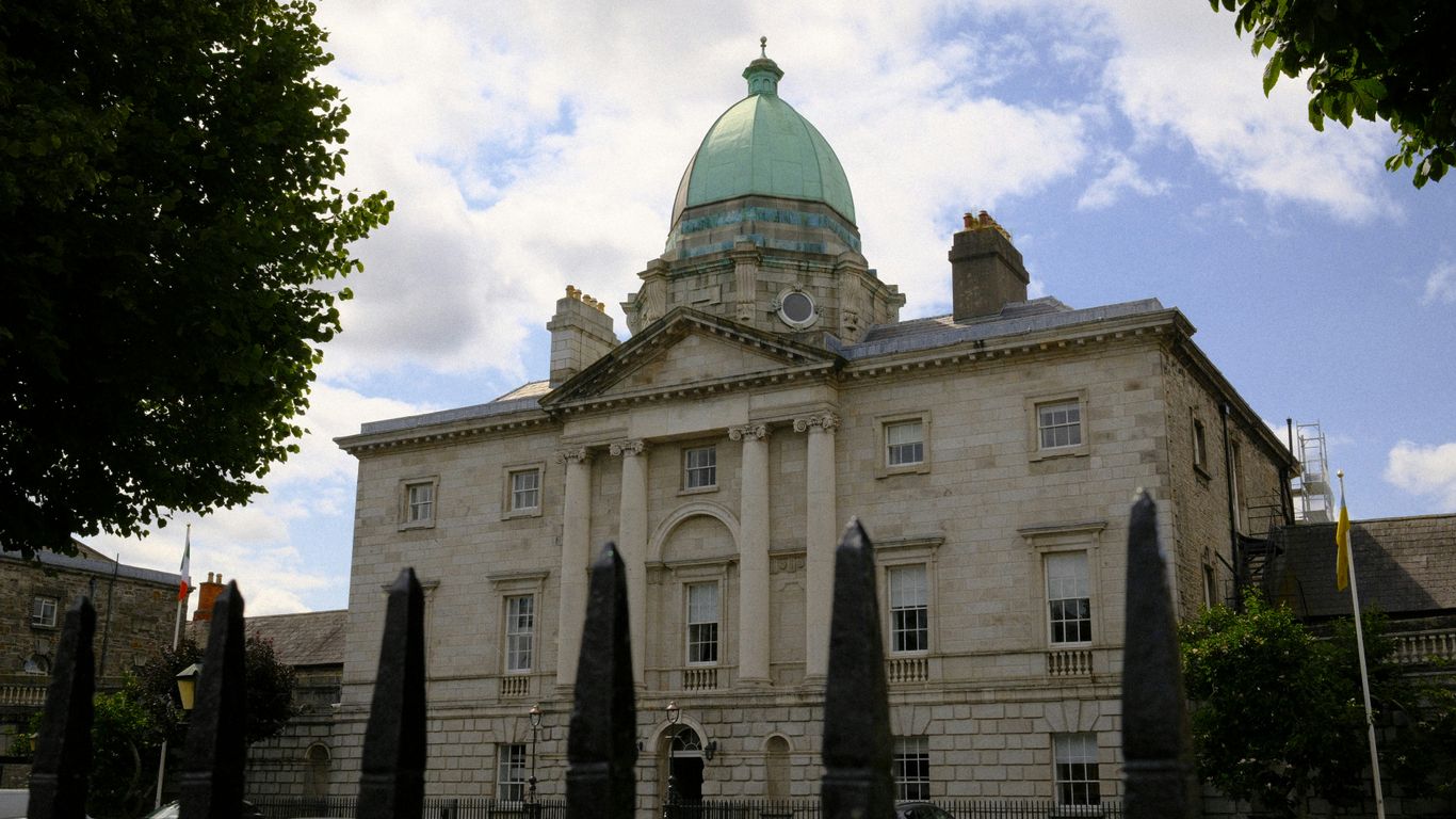 A grand building stands beneath a cloudy sky.
