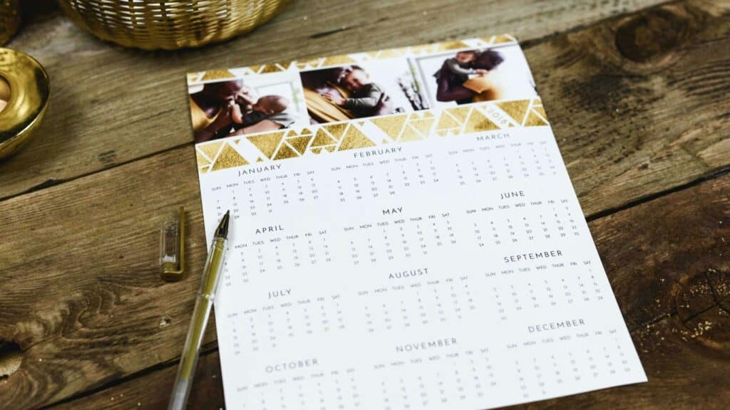 black ballpoint pen near calendar