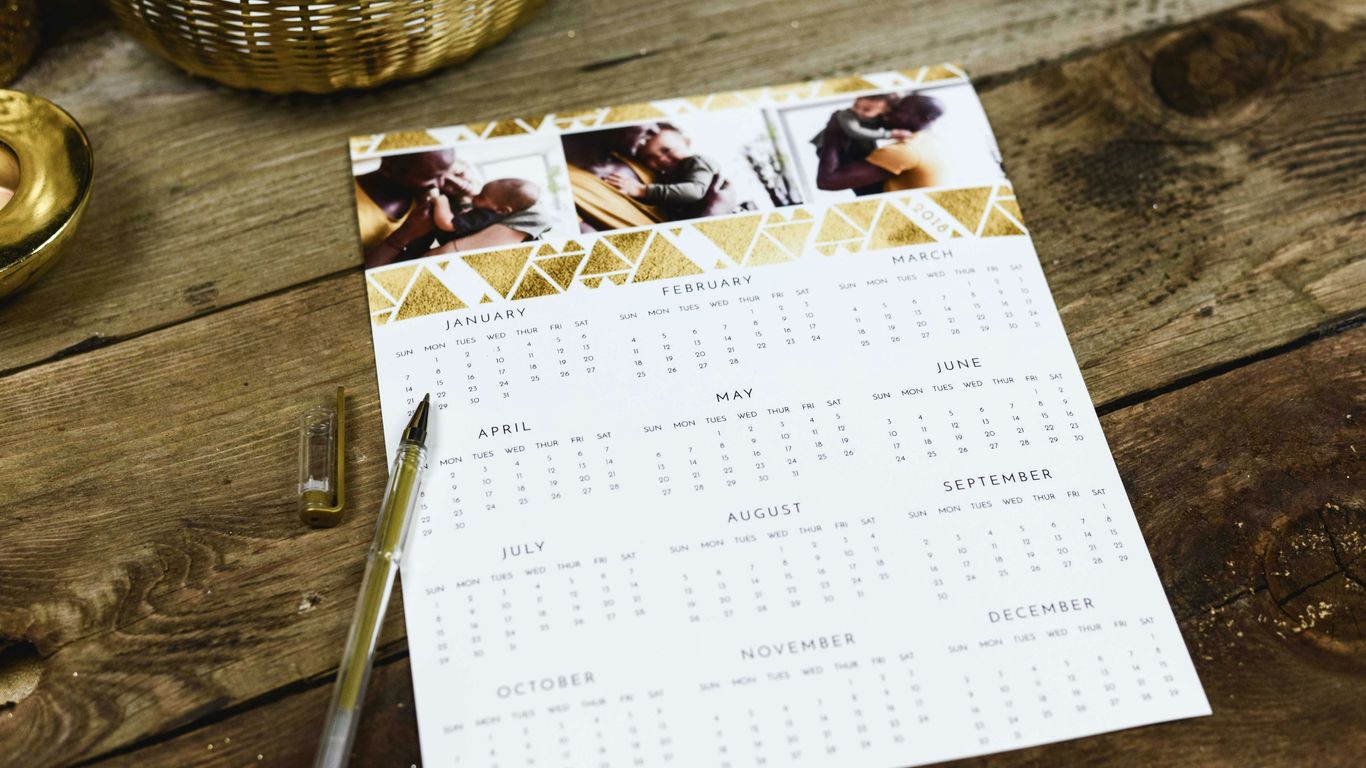 black ballpoint pen near calendar