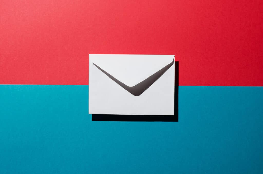 A white envelope is centered on a background divided horizontally, with red on top and blue below—symbolizing the dynamic process of building an Irish brand. The envelope casts a shadow beneath it.